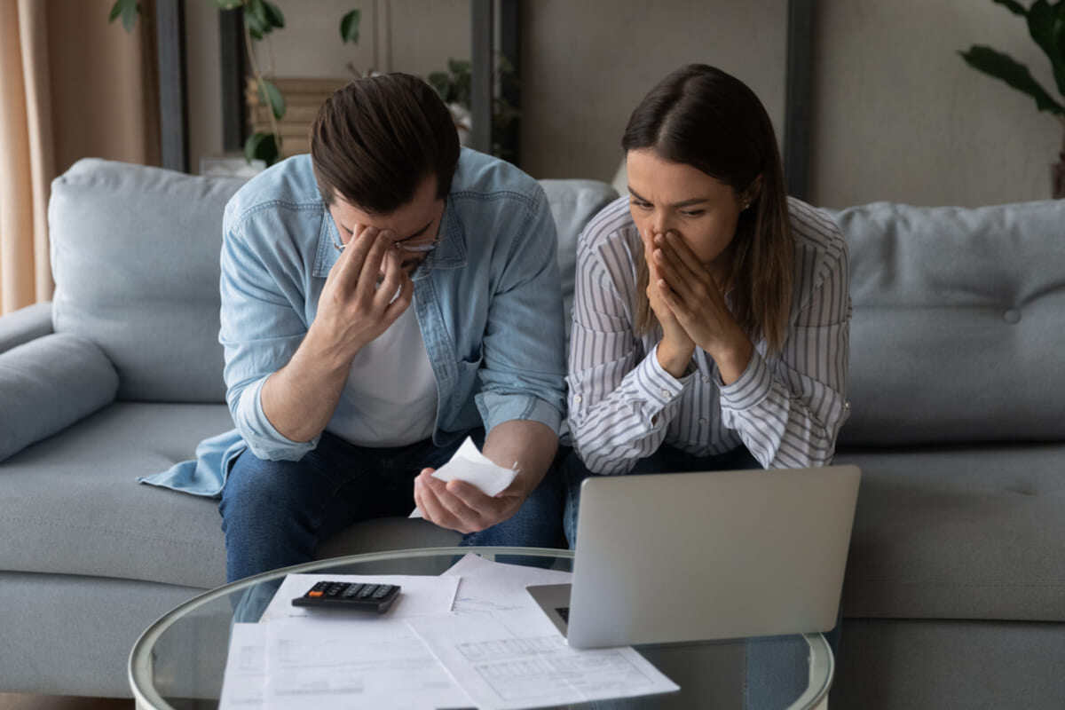 Confused and upset couple of landlords facing the bills left by a bad tenant.